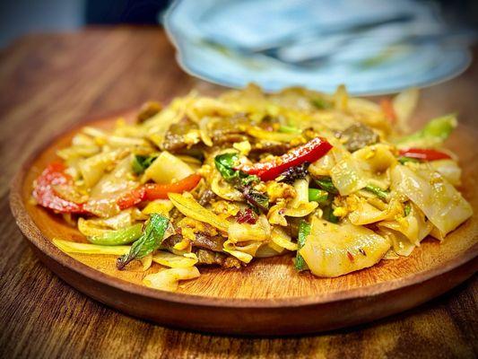 Drunken Noodles $15.95 Flat rice noodles stir fried with egg, green/red bell pepper, green onions, and basil. DELICIOUS!!!!