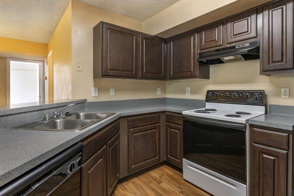 Kitchen with white and black appliances, dark espresso cabinetry, and double basin sink