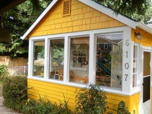 A sweet cottage nested in a beautiful outdoor area with big cedar trees.