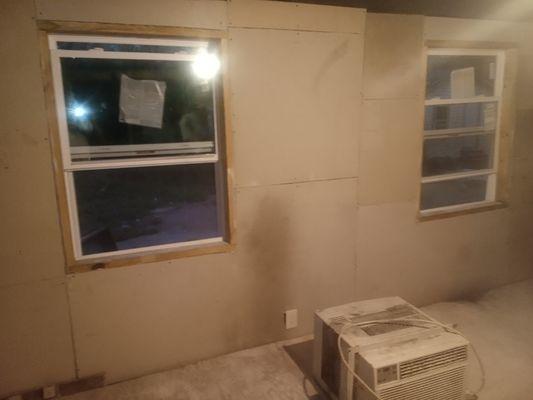 Wall, window, and drywall installation.