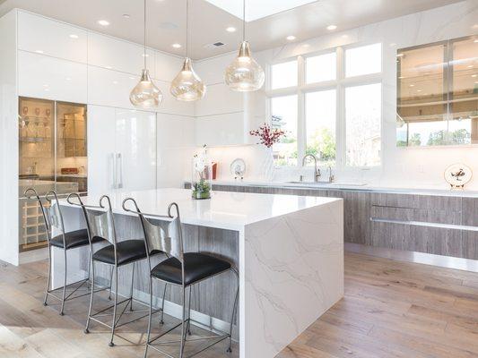 Custom kitchen waterfall countertop & full-height backsplash.