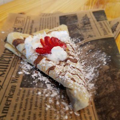 Crepe with Nutella spread, whipped cream and fresh strawberry