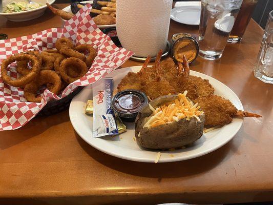 Onion rings, butterfly shrimp, baked potato