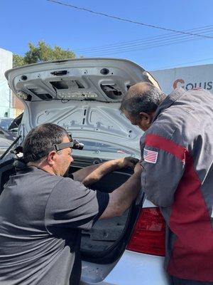 They are trying to fix the wire of the truck latch