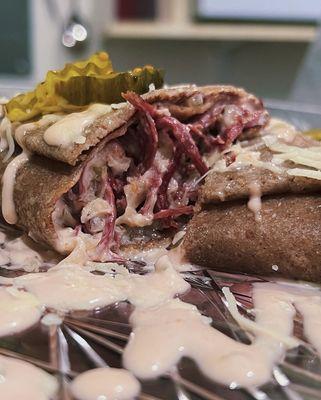 Pulled Corn Beef Rueben
Rye Crepe, pulled corn beef, with sauerkraut, Swiss cheese, homemade thousand island dressing and a side of pickles