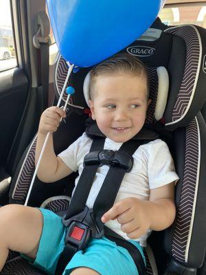 Little boy with his balloon after his haircut by Lori.