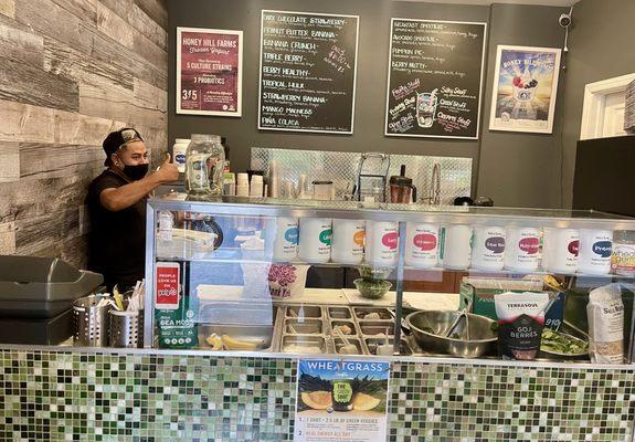 Friendly staff, counter, juice area.