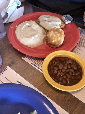 Chicken fried steak wight creamy mash potatoes, baked, beans, and a biscuit