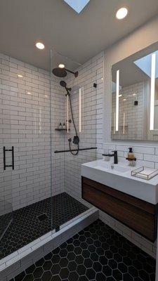 Remodeled bathroom with custom shower, 7' glass shower doors, Robern mirror and floating vanity.