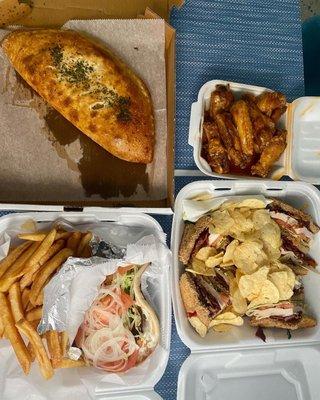 Lamb gyro platter, calzone, chicken wings, and sandwich