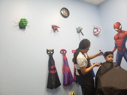 Superhero capes and designs on the wall. The place smells great too!