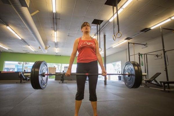 CrossFit Burien athlete at the top of the deadlift.