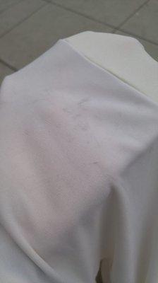 Fabric that was sewn onto the back of the shirt was stained.