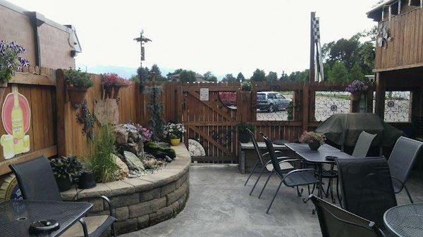 Patio with running fountain and covered smoking area.