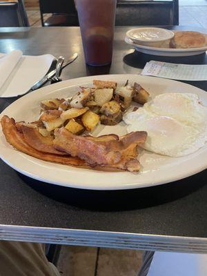 Two eggs over easy, bacon, home fries and biscuit and gravy.