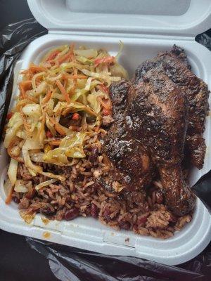 Jerk chicken with red beans and rice with veggies.