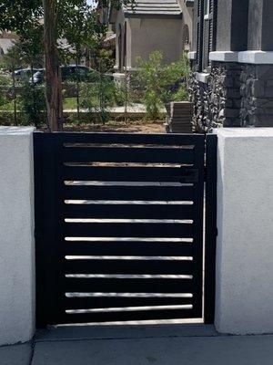 Modern Black metal front gate with lock and powder coating.