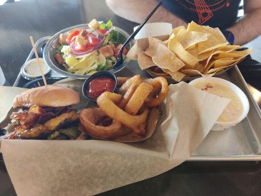 Burger, salad, onion rings and chips with queso dip!