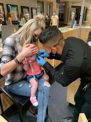 Piercing ears on 5 month old baby.