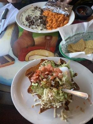 Taco salad with al pastor meat and beef with queso and rice.