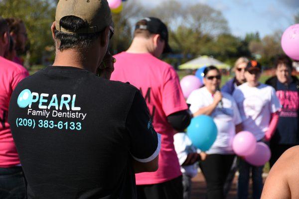 Dr. Badwalz listening as someone tells the story of her mom's first encounter with cancer. Supporting Merced Cancer Society's 5k