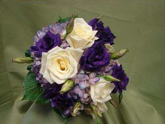 Brides bouquet of a lavender hydrangea, white roses and  purple lisianthus Evryone one loves purple