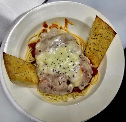 Homemade Chicken Parmigana over a spaghetti