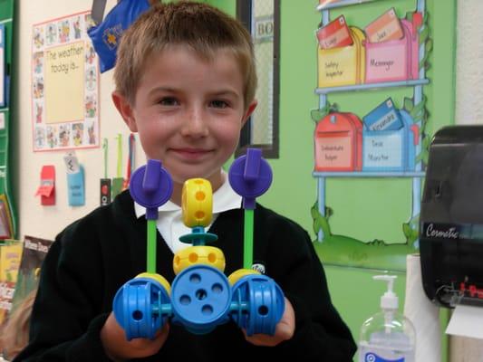 Extended Care is free for K-8th Grades; here a student shows off his creation in Junior Science Engineers.