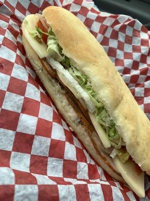 Sandwich: homemade white bread, Cajun turkey, provolone, lettuce, tomato, onion, with oil and vinegar