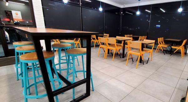 Inside the restaurant. There is one full booth, and one half booth. The rest is either high stools or chairs.