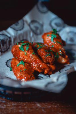 Bone-In Wings!  Choose from three homemade sauces: honey buffalo, coconut curry thai chile, & korean BBQ.  Served with buttermilk ranch.