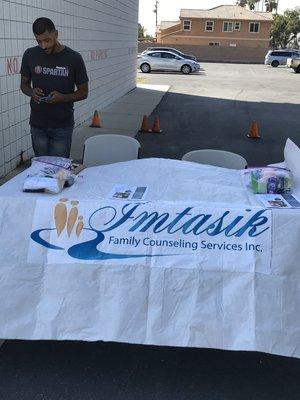 At a street fair (working with the homeless) offering free mental health counseling