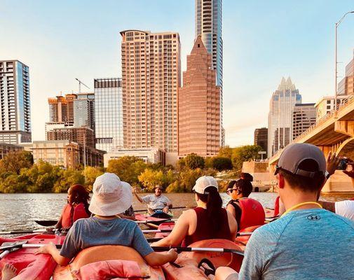 Our awesome Live Love Paddle bat tour guide in front of Downtown while we enjoyed a new perspective of Austin cruising along the lake