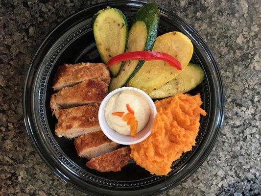 Roast pork chop with Dijon sauce, sautéed zucchini, and mashed sweet potatoes.  Only 295 Calories.  And only at the CAST Kitchen.