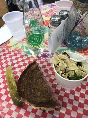 Rueben sandwich, noodle pasta, pickle, and a lemon bubbly for lunch at Sacketts