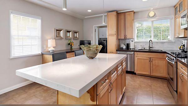 Honey Shaker Cabinets with Wild Rice Caesarstone Quartz Countertops and Dreamy Carrara Caesarstone Island Quartz Countertops.