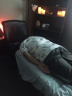 A client ready to receive gentle, healing Reiki energy while lying face down.