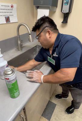 cleaning sink in break room of business