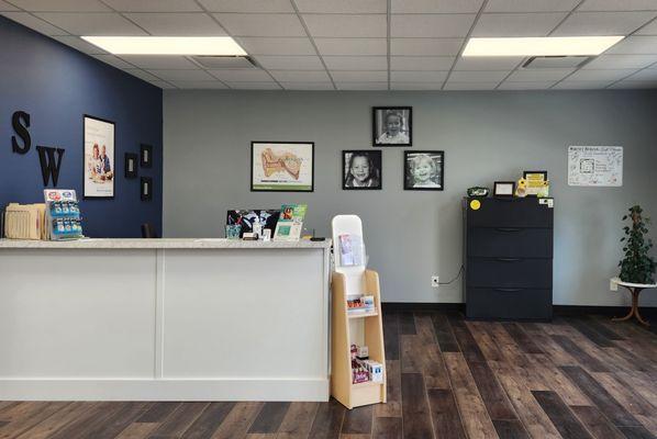 Reception area staffed by patient care coordinator.