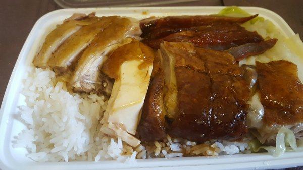 Pork, duck, and chicken over white rice and cabbage