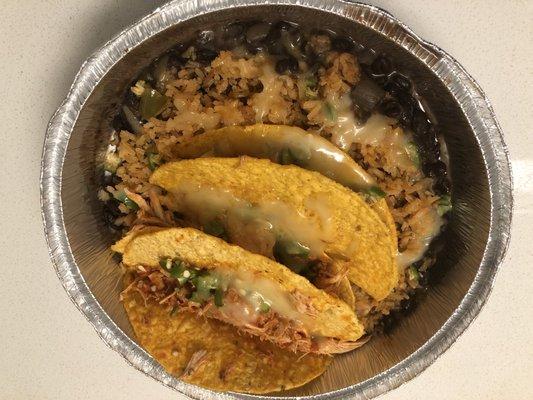 Crispy corn shell Tacos with shredded chicken, rice and black beans.