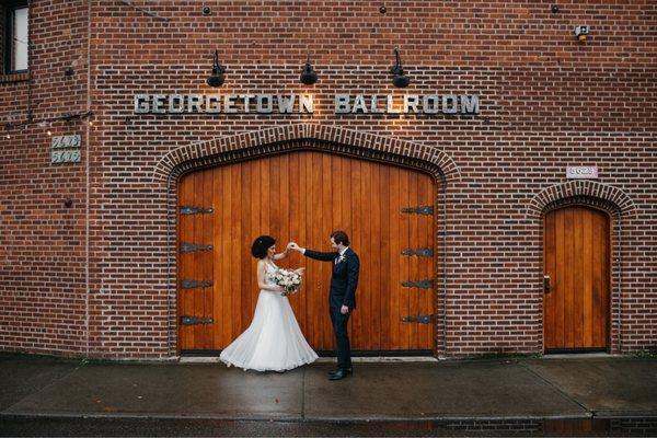 Bride and groom in front of venue