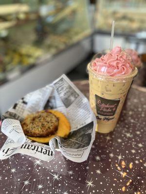 Cold brew with pink whip and breakfast sandwich.