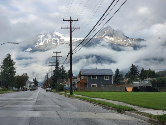 Skagway view of the mountains along the edge of the ocean and draped in cloud ribbons.