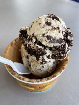 Two scoops are in a waffle bowl Peanut butter oreo Coffee oreo