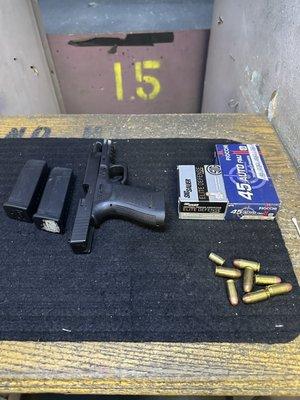 Slide open for safety    pistol pointing down range no mags in pistol. Renting Glock # 21 45 Cal  pistol at Westside Gun range.