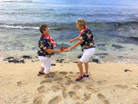 This awesome couple is having fun tossing the water back into the ocean after the service.