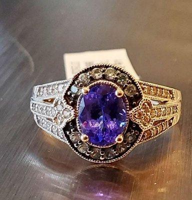 Oval natural violet-blue tanzanite in a 14kw gold, vintage style setting w/ diamond accents