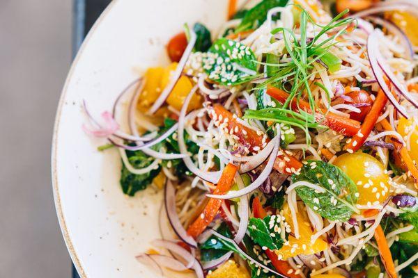 Asian Noodle Bowl: vermicelli noodles, peppers, cherry tomatoes, orange segments, roasted peanuts, cilantro, mint, red