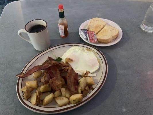 Bacon, eggs, country potatoes, coffee, toast and jelly!